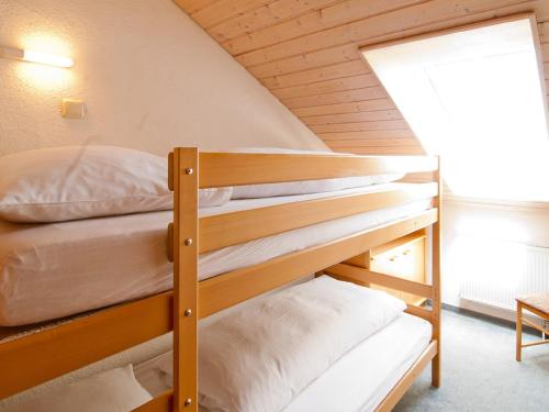 two bunk beds in a room with a window at Landhaus am Kienberg in Pfronten