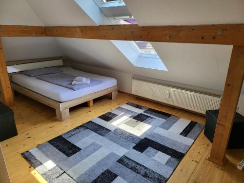 a attic room with a bed and a rug at Hotel, Ferienwohnung, Zimmer in Bad Driburg