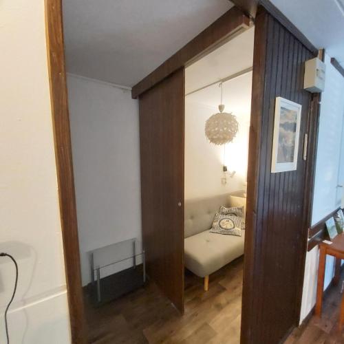 a living room with a couch and a mirror at Top Nyaraló Mindszent in Mindszent