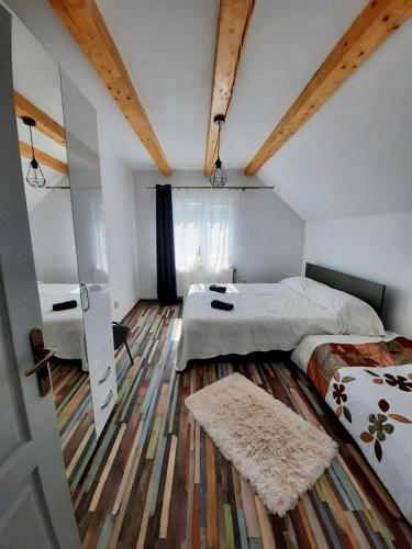 a bedroom with two beds and a rug at Retreat Activ in Cluj-Napoca