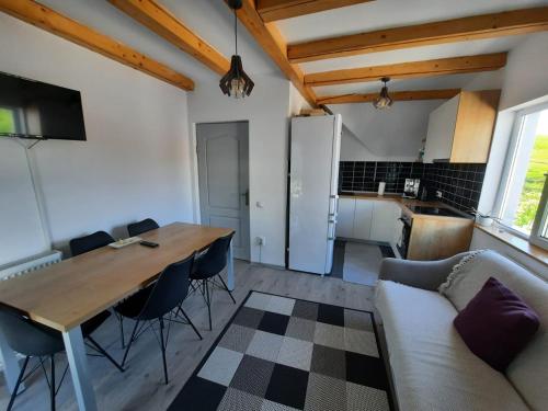 a kitchen and dining room with a table and chairs at Retreat Activ in Cluj-Napoca