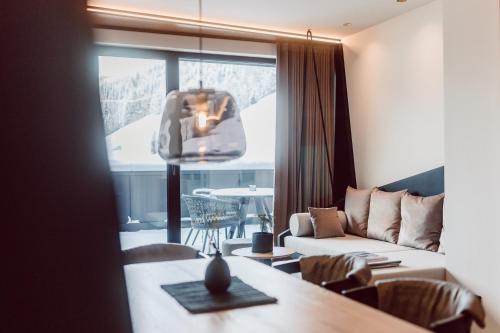 a living room with a couch and a table at JoAnn suites & apart in Kleinarl