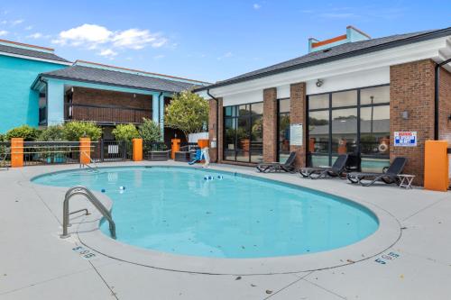 a large swimming pool in front of a building at Garnet Inn & Suites, Morehead City near Atlantic Beach in Morehead City