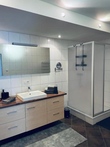 a bathroom with a sink and a shower at Mountainfloor in Grossarl