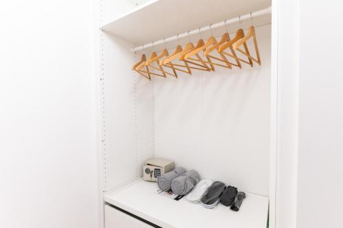 a closet with white walls and a white shelf at Villa Lilith Smart in Fertőrákos