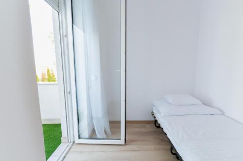 a mirror in a room with a bed and a window at Villa Lilith Smart in Fertőrákos