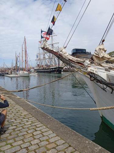 a boat is docked in a harbor with other boats at Aux prés verts in Fécamp