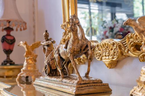 a gold statue of a horse on a table at Prezident Palace Belgrade - Adults Only in Belgrade