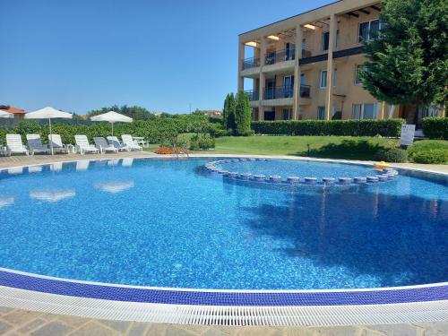 a large swimming pool in front of a building at Sozopoli Hills, app B7 in Sozopol