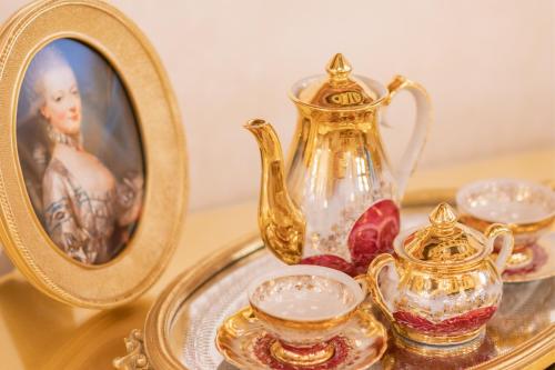 a tray with a mirror and a tea set and a pitcher at Prezident Palace Belgrade - Adults Only in Belgrade