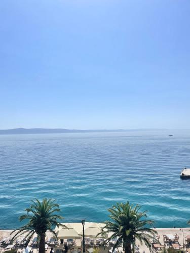a view of a large body of water with palm trees at Waterfront Roko in Podgora
