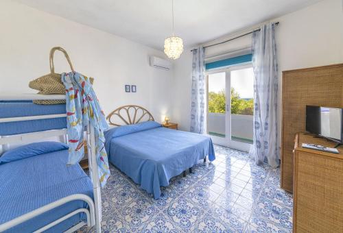 a bedroom with two beds and a television at Bristol Hotel in Ischia