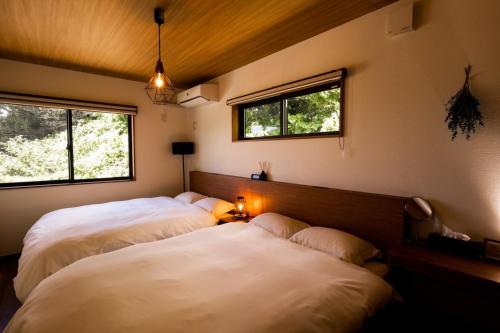 Ένα ή περισσότερα κρεβάτια σε δωμάτιο στο 山里の家