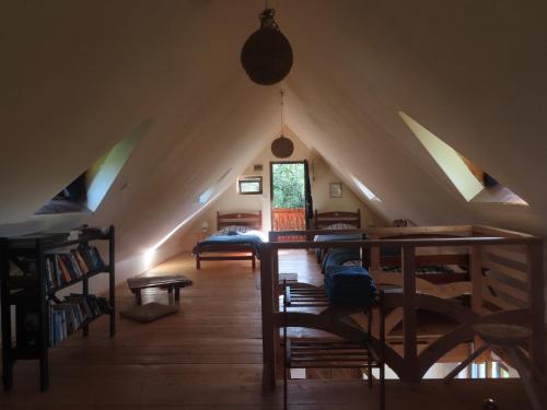 a attic room with a vaulted ceiling and a bedroom at Babou Maramures in Breb