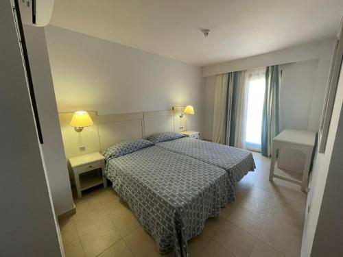 a hotel room with a bed and a window at JARDINES DE ISLA CANELA By SIT ISLA CANELA -REF 171- in Isla Canela