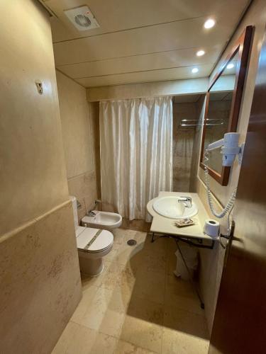 a bathroom with a sink and a toilet and a mirror at JARDINES DE ISLA CANELA By SIT ISLA CANELA -REF 171- in Isla Canela