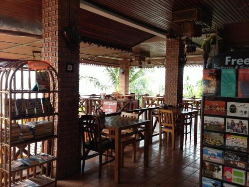 a restaurant with tables and chairs in a room at Hi coral cove bungalow in Chaweng Noi Beach