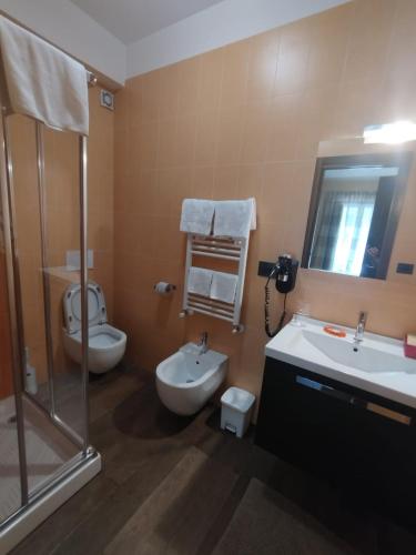 a bathroom with a shower and a toilet and a sink at B&B IL GHIRO in Roccaraso
