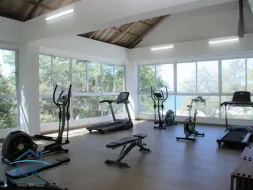a gym with many exercise bikes in a room with windows at Club de Playa Samaria - T1 APTO 1705, Santamarta in Santa Marta