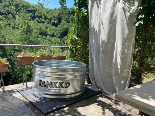 a large metal bucket sitting on a table with a view at La Limonaia di Casagrande in Barga