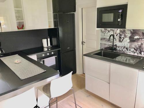 a kitchen with a sink and a microwave at Ögränd 2 - Nyrenoverad toppmodern lägenhet in Sveg