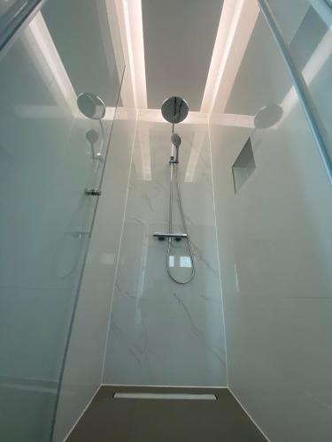 a bathroom with a shower with a glass wall at Villa Tri Brata in Podstrana