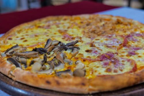 a pizza sitting on top of a table at LORD Hotel in Tirana
