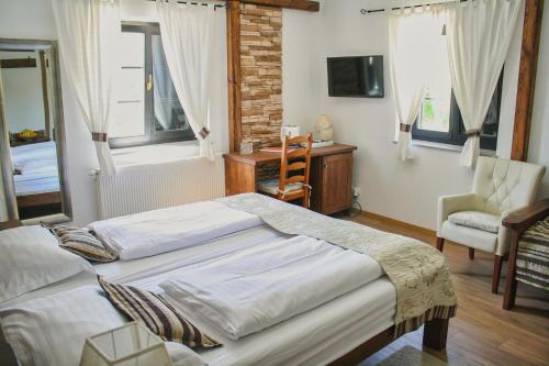 a bedroom with two beds and a desk and a chair at Green Garden Plitvice lakes in Plitvica selo
