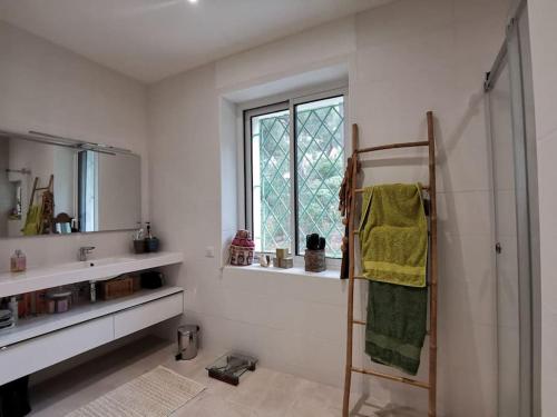 a white bathroom with a shower and a window at Bestouan - 3 Chambres - Clim - Spacieux in Cassis