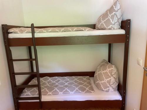 a couple of bunk beds with pillows on them at Ferienhaus Sandsteinwandblick in Schöna