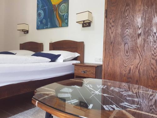a bedroom with two beds and a glass table at Green Garden Plitvice lakes in Plitvica selo