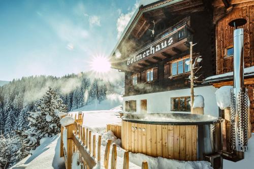 a building with a hot tub in the snow at Golmerhaus in Schruns-Tschagguns