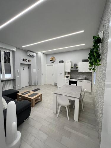 a living room with a table and a kitchen at CA FOSCARI HARMONY Jacuzzi Apartment in Milan