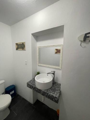 a bathroom with a sink and a toilet at Las Olas Beach apartments in Arecibo