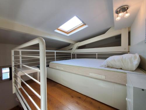 a bedroom with a bunk bed and a skylight at Le Victor Hugo in Nice