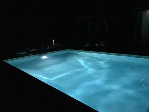 a large swimming pool lit up at night at la dolce farniente in Biaudos
