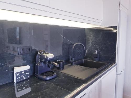 a kitchen counter with a sink with a coffee maker at TERRAZA AL MAR in Aguadulce