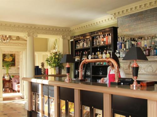 a woman sitting at a bar in a room at 10 Castle St in Cranborne