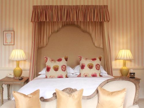 a bedroom with a large bed with pillows on it at 10 Castle St in Cranborne