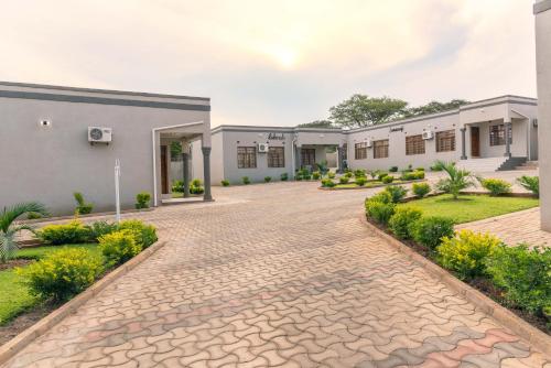 a courtyard of a building with a brick driveway at Luxurious Chimwemwe II - Kat-Onga Apartments in Lusaka
