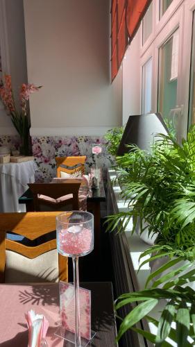 a wine glass sitting on a table with plants at Hotel Wiosna in Rabka