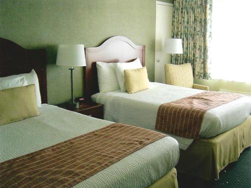 a hotel room with two beds and a window at Pier 4 Hotel in Somers Point