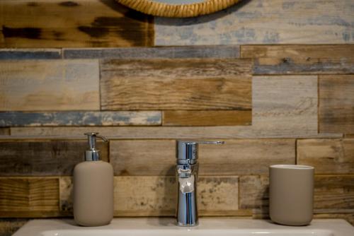 - un lavabo dans la salle de bains avec deux distributeurs de savon dans l'établissement ApartsW241, à Jelenia Góra