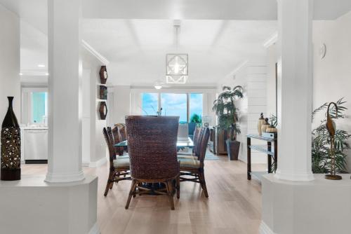 a dining room with a table and chairs at Hidden Dunes 304 in Panama City Beach