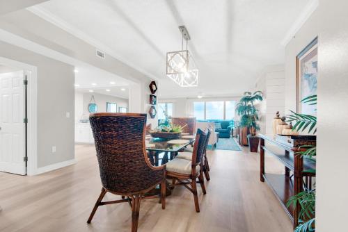 a dining room and living room with a table and chairs at Hidden Dunes 304 in Panama City Beach