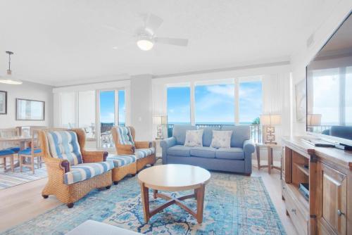 a living room with a couch and chairs and a table at Hidden Dunes 304 in Panama City Beach