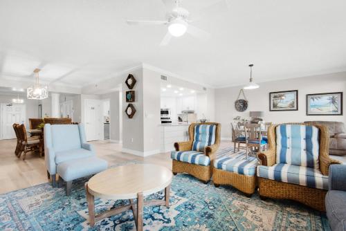 a living room with a couch and chairs and a table at Hidden Dunes 304 in Panama City Beach