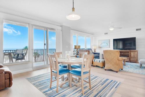 a dining room with a table and chairs and a living room at Hidden Dunes 304 in Panama City Beach