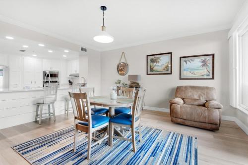 a kitchen and dining room with a table and chairs at Hidden Dunes 304 in Panama City Beach