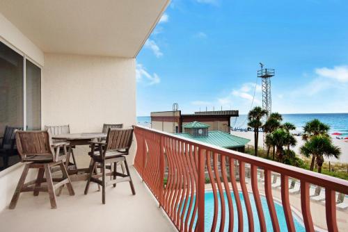 a balcony with a table and chairs and the ocean at Hidden Dunes 304 in Panama City Beach